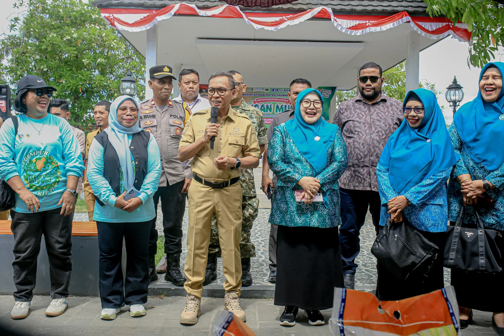 Bupati Halteng Dr. Ir. Ikram Malan Sangadji, M.Si, didampingi Ketua TP-PKK Halteng Ny. Rallia Asyari Ikram dan jajaran Pemkab Halteng serta Anggota DPRD saat memberikan arahan pada pembukaan Gerakan Pangan Murah di Taman Kota, Desa Were, Weda, Selasa (4/8/2026). (Foto: Supriansyah Nurdin)